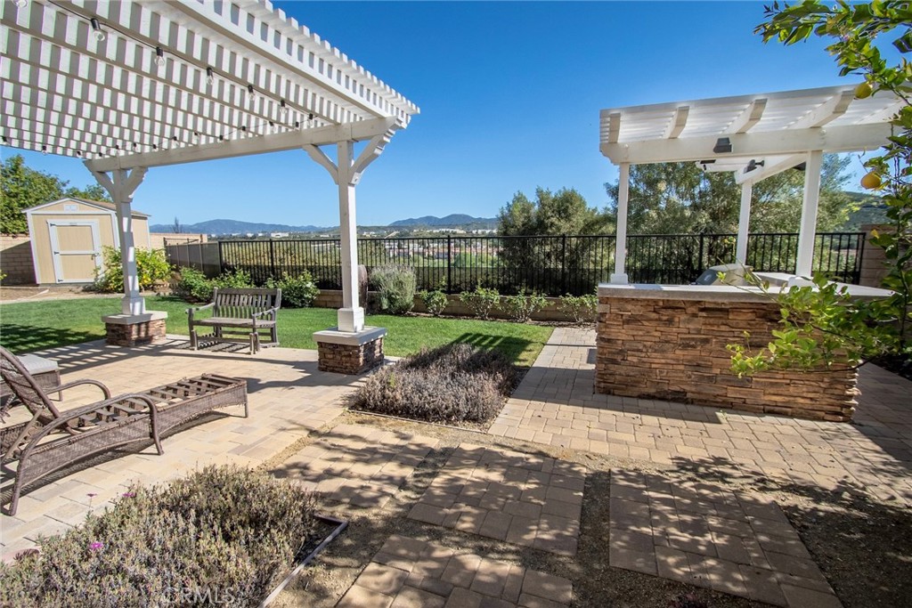 26424 Township Street Saugus, CA 91350 - Photo 25 of 72 a view of a patio with a table and chairs under an umbrella