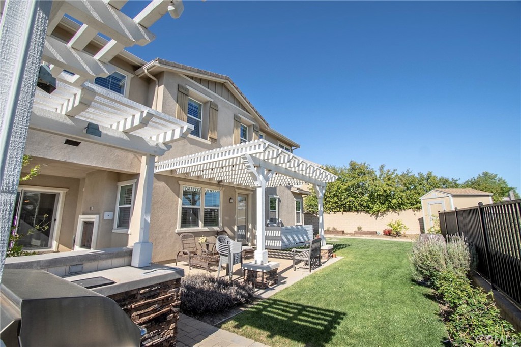 26424 Township Street Saugus, CA 91350 - Photo 27 of 72 a view of a patio with table and chairs with wooden fence and plants