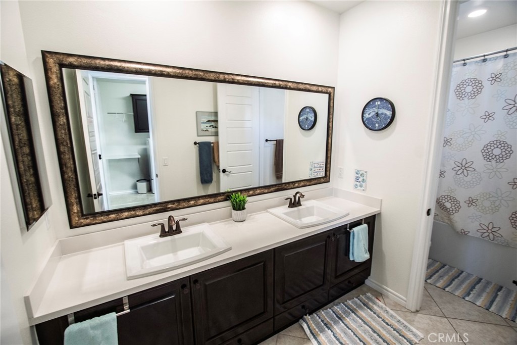 26424 Township Street Saugus, CA 91350 - Photo 35 of 72 a bathroom with a double vanity sink and a mirror