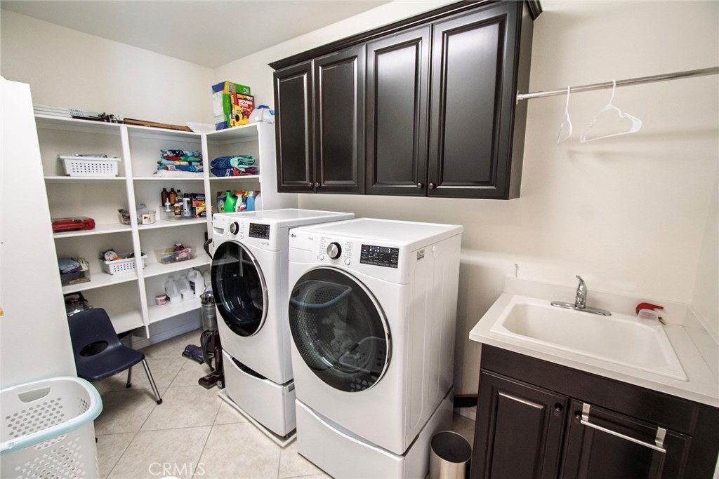 26424 Township Street Saugus, CA 91350 - Photo 36 of 72 a utility room with dryer washer and a sink