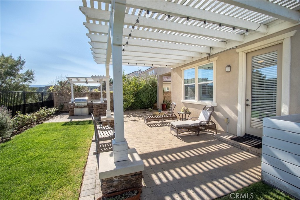 26424 Township Street Saugus, CA 91350 - Photo 70 of 72 a view of a patio with couches table and chairs and potted plants