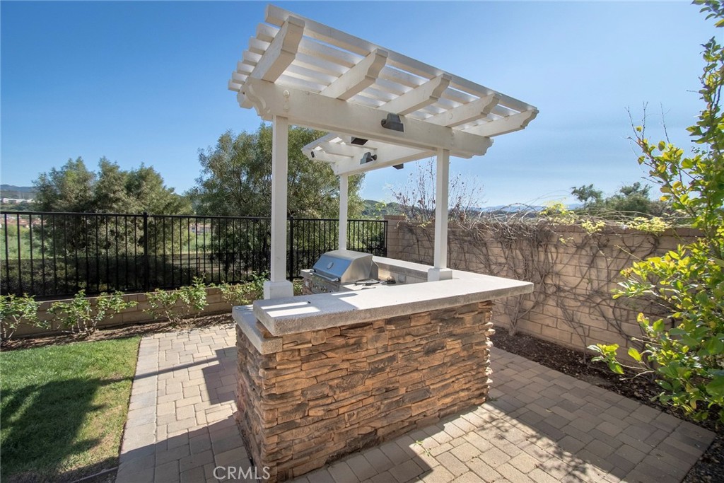 26424 Township Street Saugus, CA 91350 - Photo 72 of 72 a view of a patio with table and chairs potted plants with wooden floor