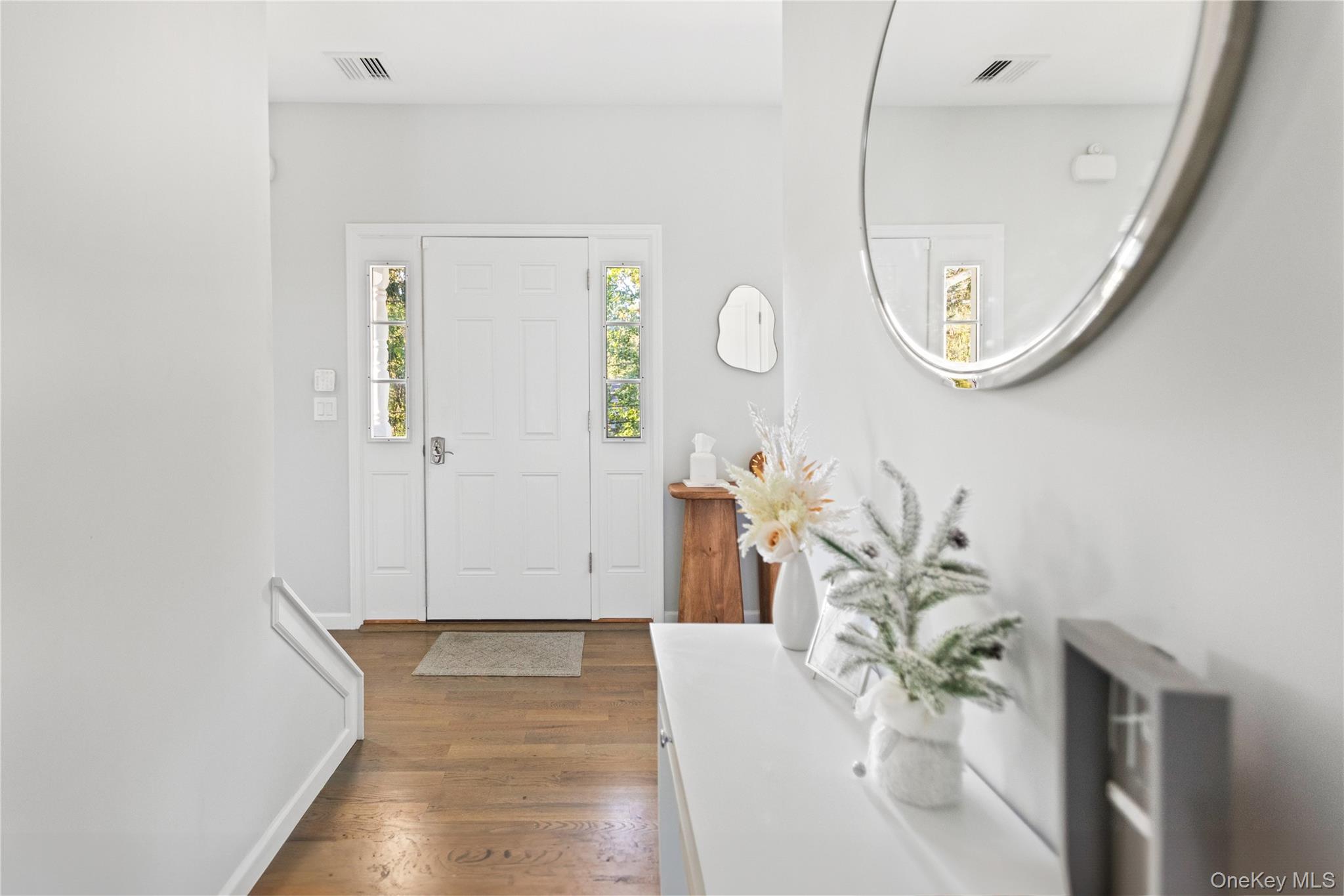24 Belmont Road Sound Beach, NY 11789 - Photo 3 of 23 a view of a hallway to a livingroom with furniture