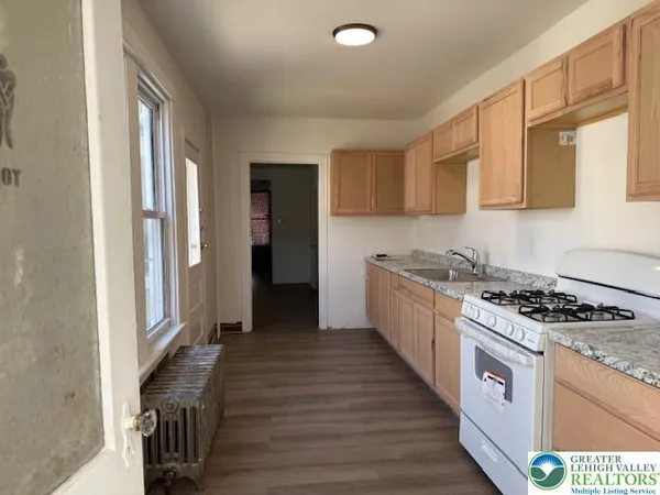 a kitchen with granite countertop a stove and a sink