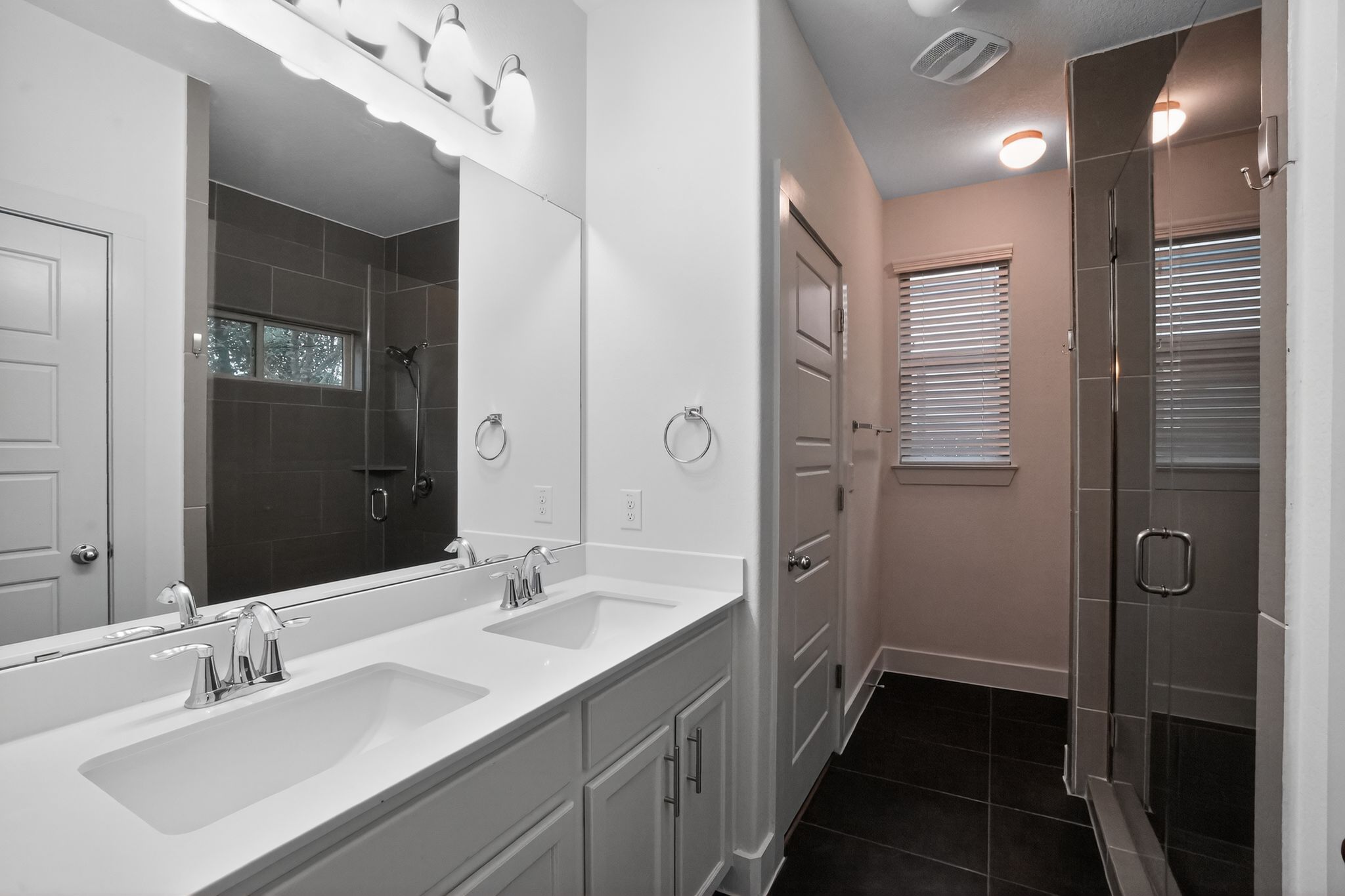 9717 Briny Shell Way Austin, TX 78748 - Photo 10 of 16 Full bathroom featuring a stall shower, double vanity, and dark tile patterned flooring