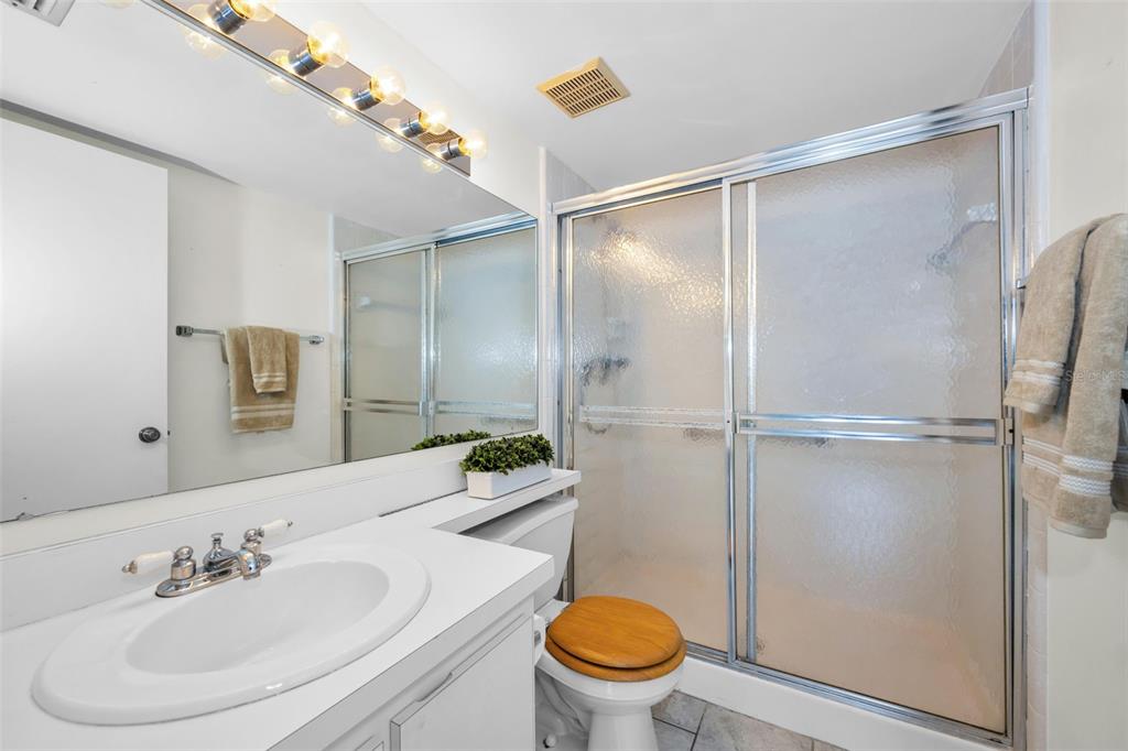 2687 Pine Ridge Way South, Unit B2 Palm Harbor, FL 34684 - Photo 23 of 68 a bathroom with a sink toilet and shower