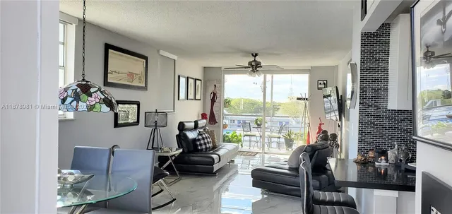 a living room with furniture and floor to ceiling windows