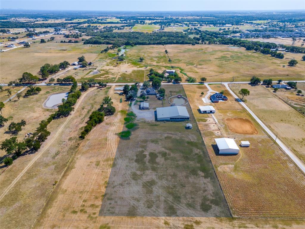 1601 East Blackjack Road East Pilot Point, TX 76258 - Photo 31 of 33 Expansive property featuring a main residence, multiple auxiliary buildings, a pond, and a large open field