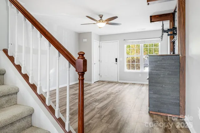 a view of an entryway with wooden floor and stairs