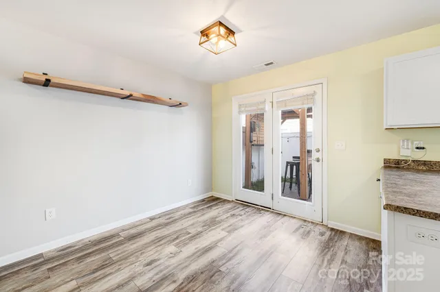 a kitchen with granite countertop a refrigerator and a stove top oven