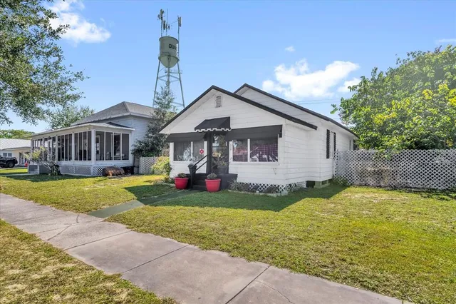 a view of a house with a yard patio and fire pit