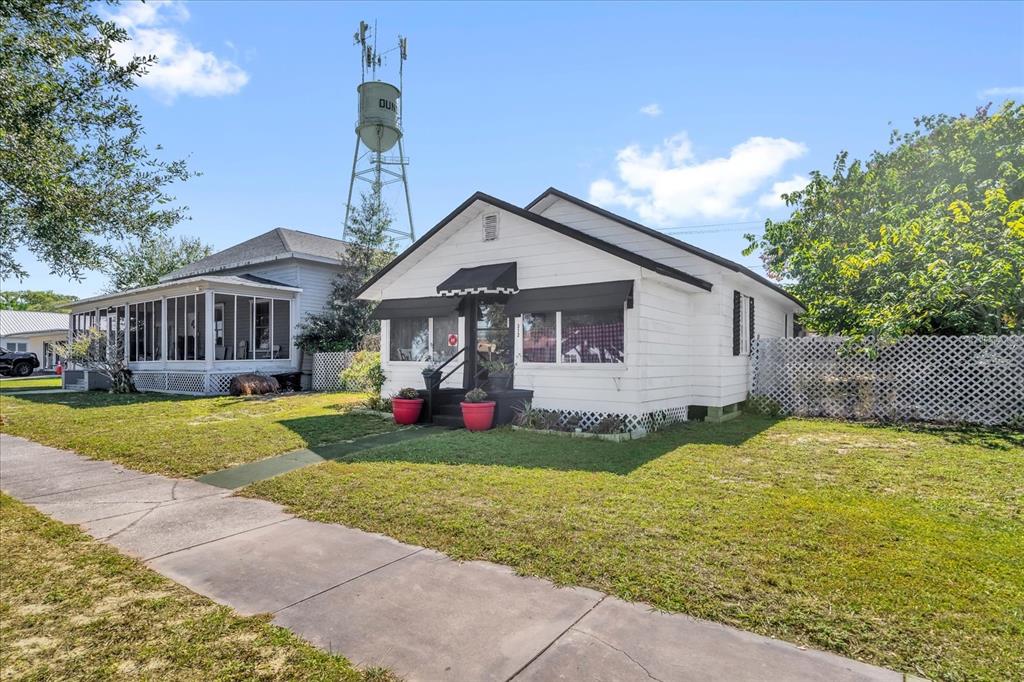 312 East Main Street Dundee, FL 33838 - Photo 2 of 27 a view of a house with a yard patio and fire pit