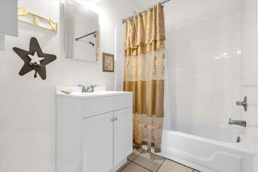 312 East Main Street Dundee, FL 33838 - Photo 8 of 27 a bathroom with a sink vanity and tub