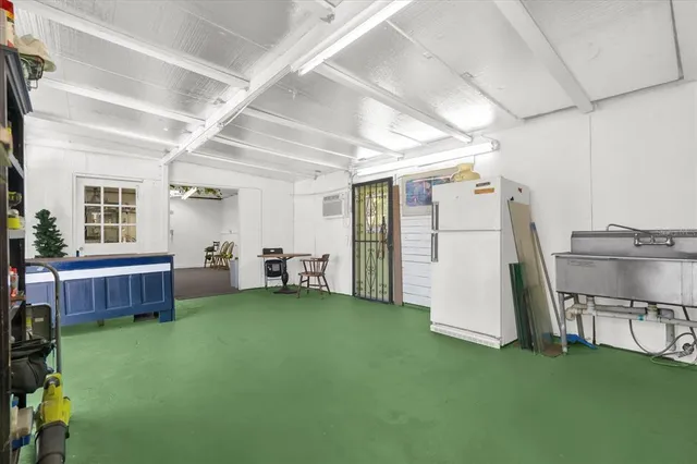 a dining room with furniture and a floor to ceiling window