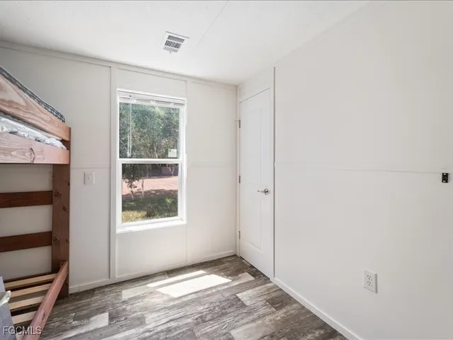 a view of room with hardwood floor and bathroom