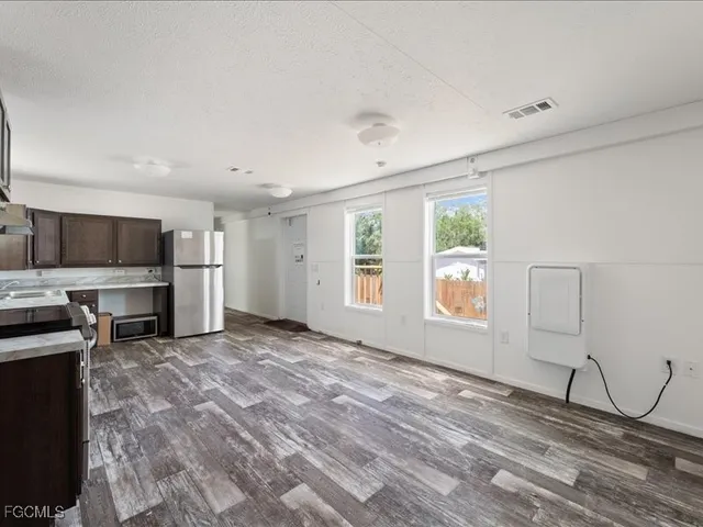 a kitchen with stainless steel appliances granite countertop a sink and stove top oven