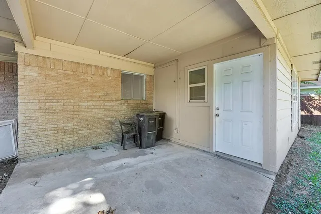 a view of a room with table and chairs