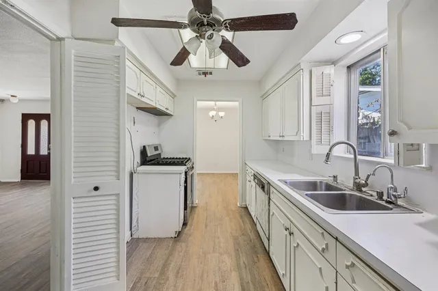 a kitchen with stainless steel appliances a sink stove and refrigerator