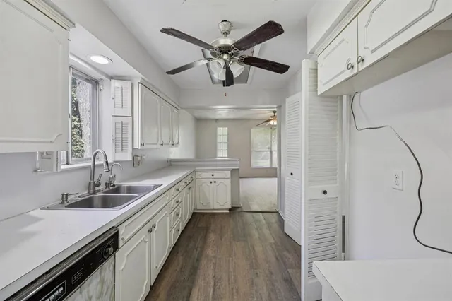 a kitchen with a sink and a refrigerator