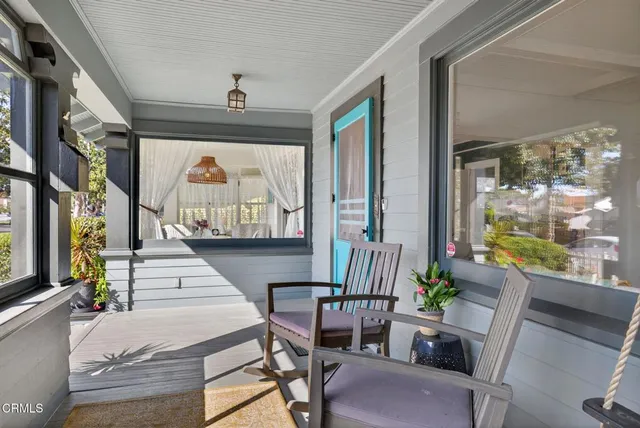 a dining room with furniture wooden floor a rug and a chandelier