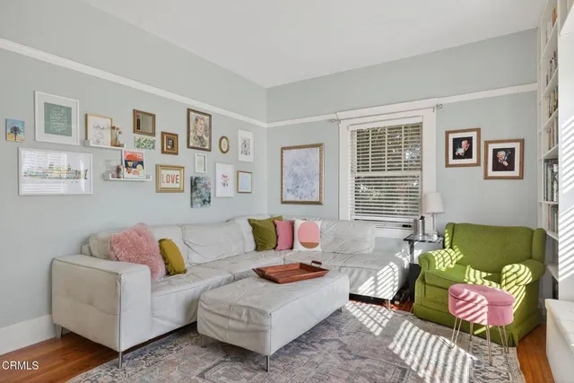 a view of a patio with couches table and chairs and potted plants