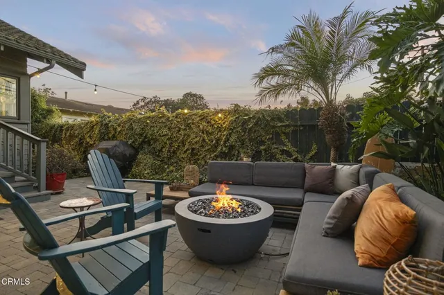 a front view of a house having yard and tree