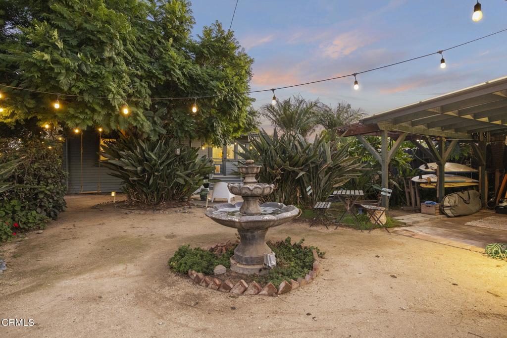 407 Magnolia Avenue Oxnard, CA 93030 - Photo 10 of 76 a view of a patio with table and chairs potted plants and large tree
