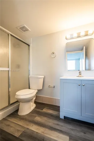 a bathroom with a toilet sink and a mirror