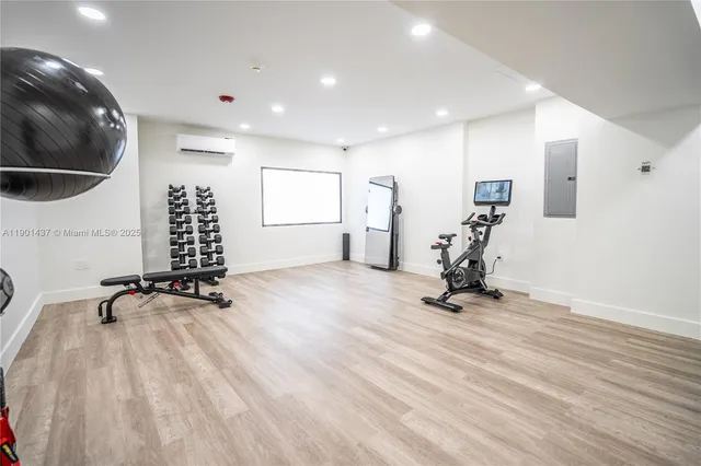 a view of a room with gym equipment and a large window