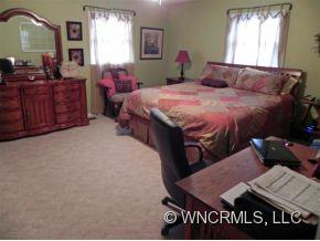 682 South Mountain Road Bostic, NC 28018 - Photo 5 of 12 a bedroom with a bed and dresser with mirror