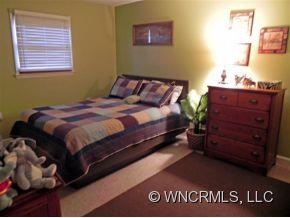 682 South Mountain Road Bostic, NC 28018 - Photo 7 of 12 a bed sitting in a bedroom next to a window