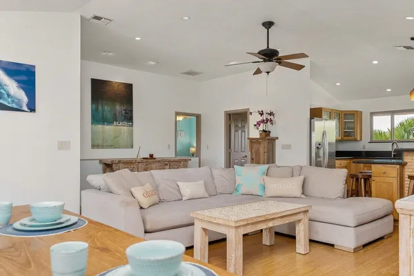 a living room with furniture and a wooden floor