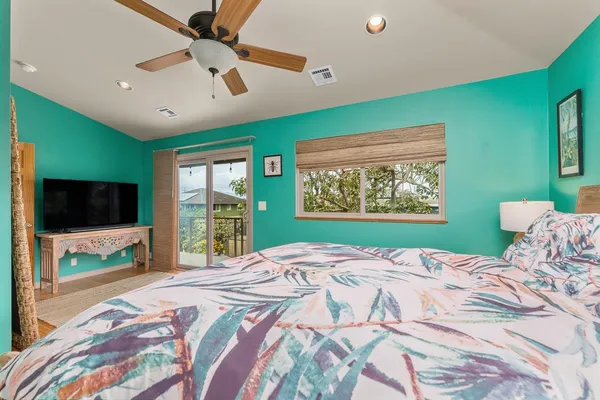 a bedroom with a large bed and a flat screen tv