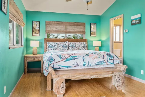 a bed sitting in a bedroom next to a window