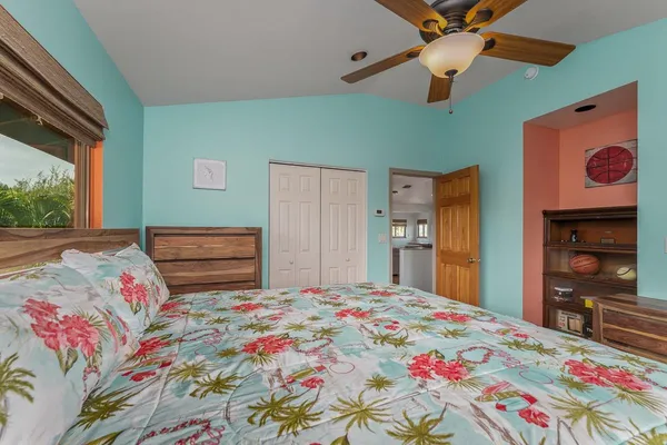 a bedroom with a bed dresser and a window