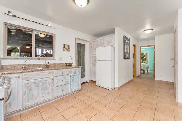 a large bathroom with a granite countertop sink and a large mirror