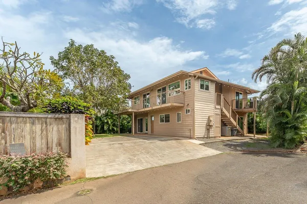 a front view of a house with a garden