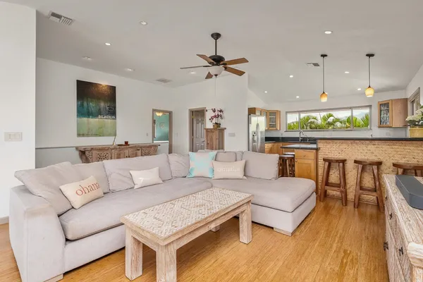 a living room with furniture and a wooden floor