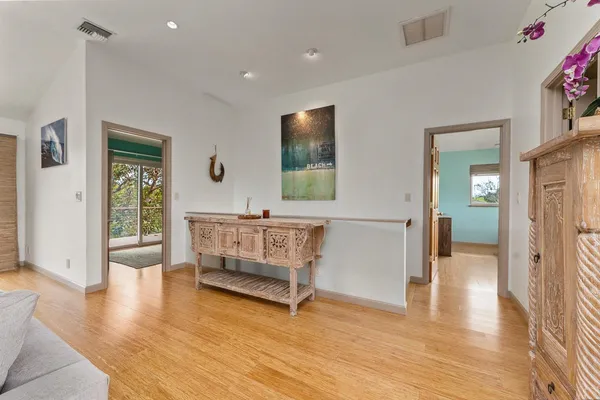 a living room with furniture and a wooden floor