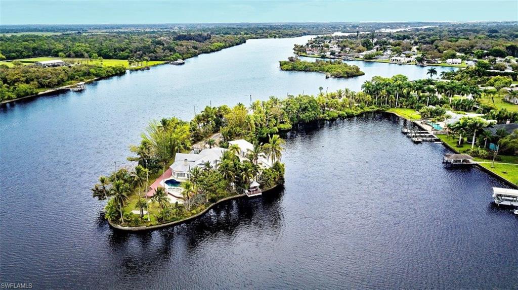 14524 Riverside Drive Fort Myers, FL 33905 - Photo 1 of 23 an aerial view of a house with a yard and lake view