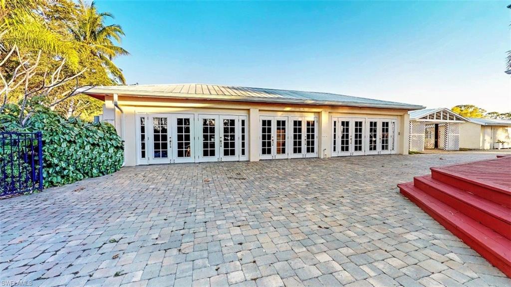 14524 Riverside Drive Fort Myers, FL 33905 - Photo 21 of 23 a porch with a table and chairs