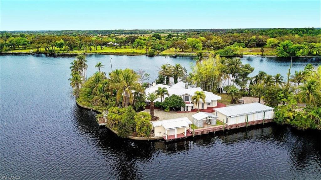 14524 Riverside Drive Fort Myers, FL 33905 - Photo 4 of 23 a view of a lake with a table and chairs