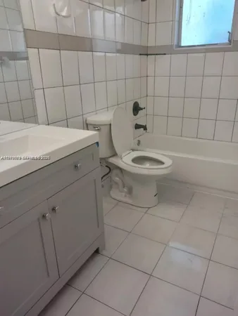 a bathroom with a toilet and a bathtub