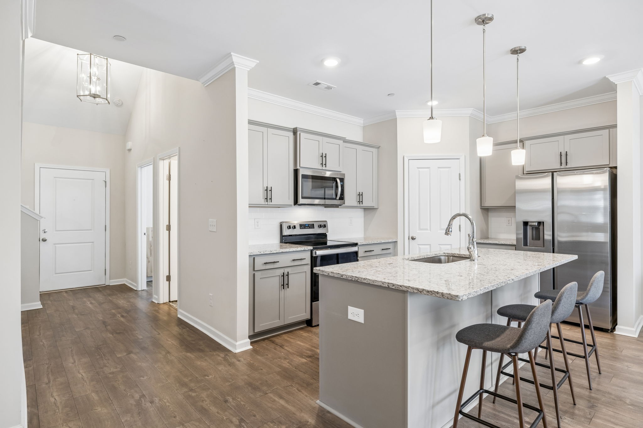 7503 Fernvale Springs Way Fairview, TN 37062 - Photo 11 of 60 a kitchen with a sink a center island a stove and a refrigerator