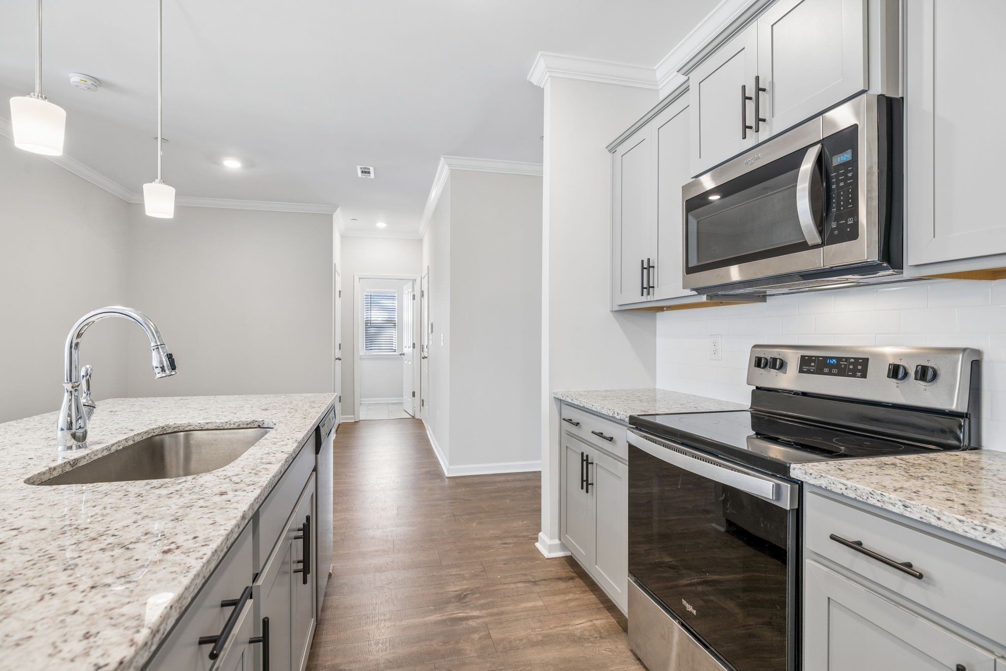 7503 Fernvale Springs Way Fairview, TN 37062 - Photo 23 of 60 a kitchen with stainless steel appliances granite countertop a sink stove and microwave