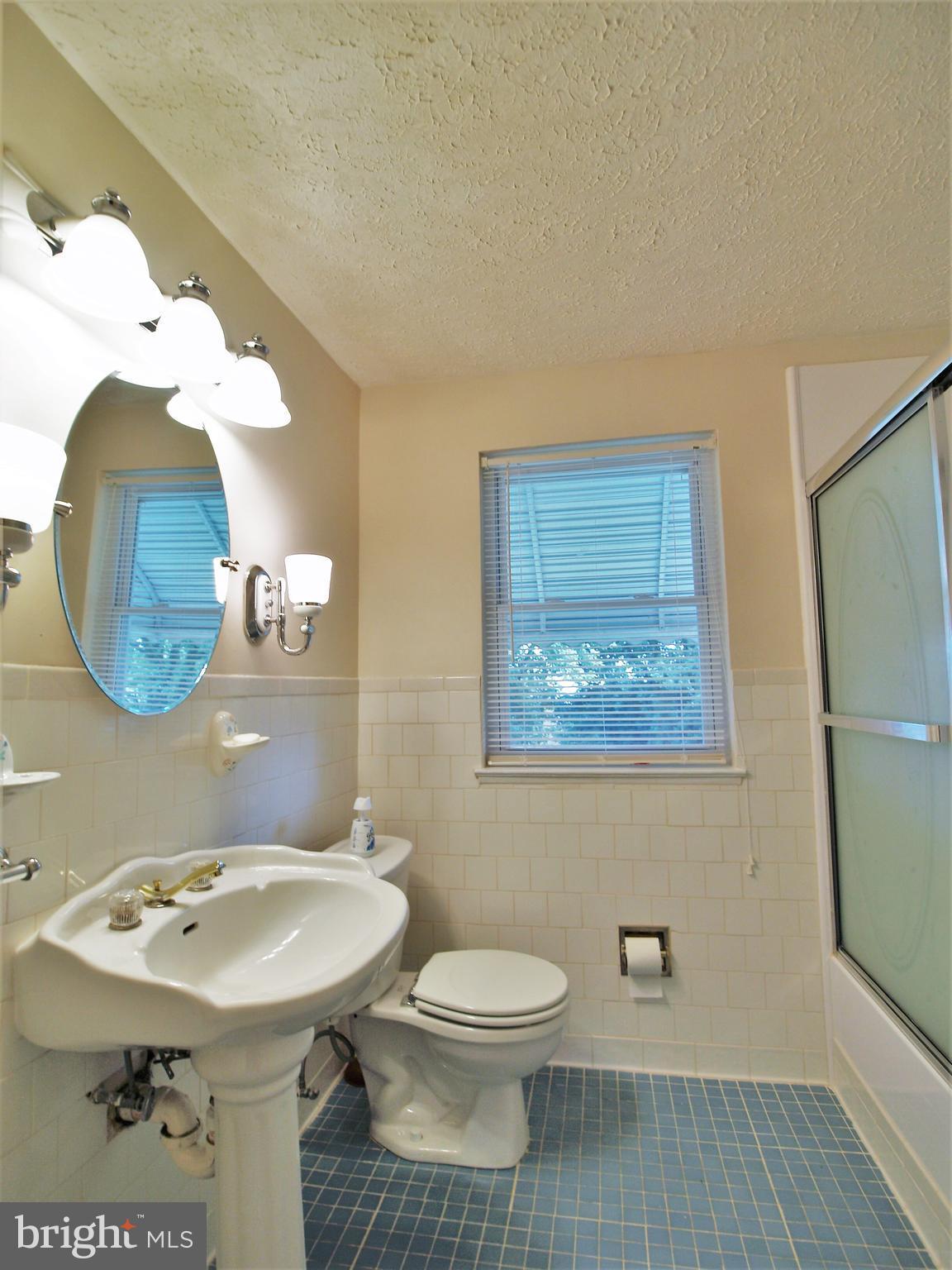 652 Charraway Road Baltimore, MD 21229 - Photo 15 of 22 a bathroom with a sink mirror and toilet