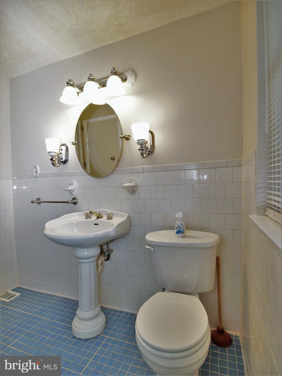 652 Charraway Road Baltimore, MD 21229 - Photo 16 of 22 a bathroom with a toilet a sink and a mirror