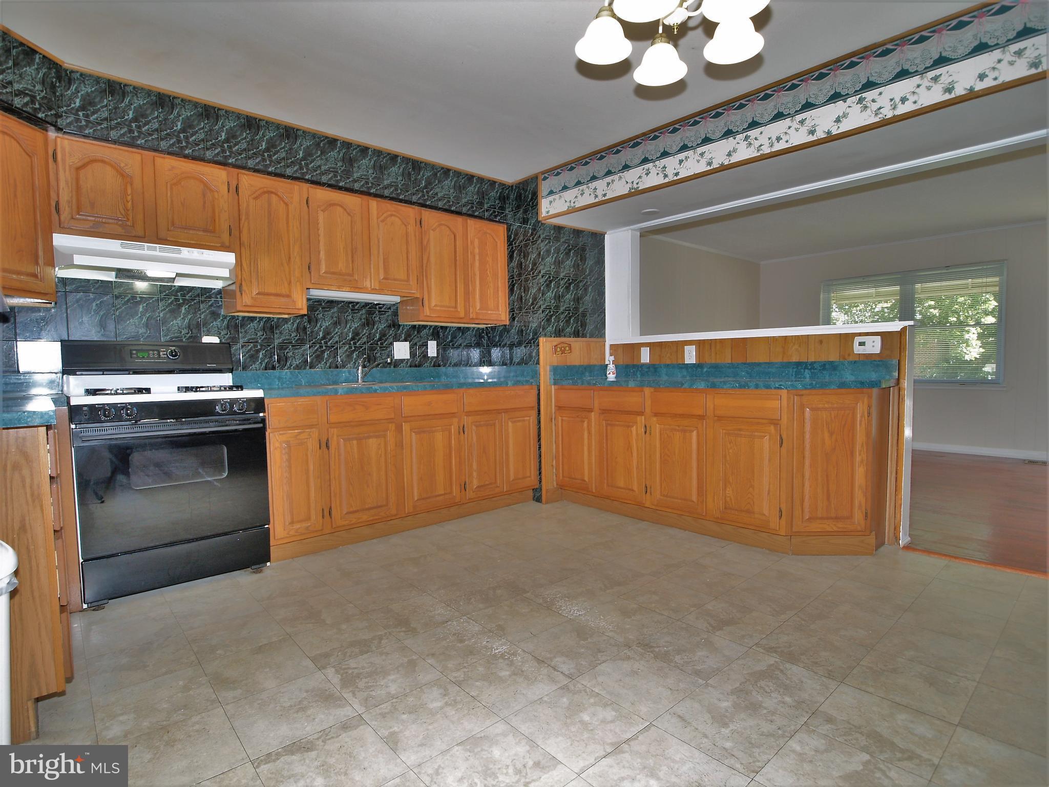 652 Charraway Road Baltimore, MD 21229 - Photo 8 of 22 a view of a kitchen with a sink and cabinets