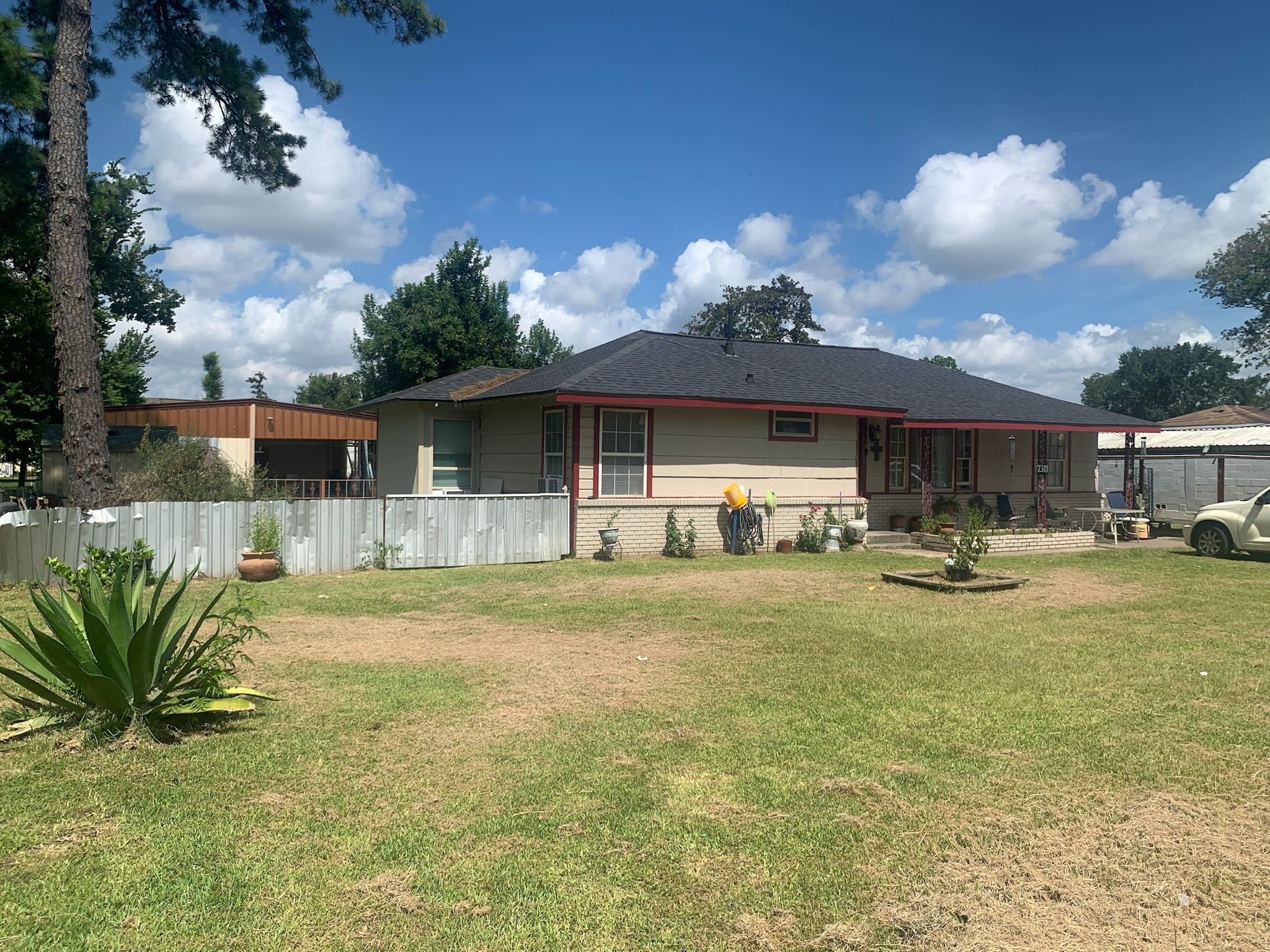 7311 Roswell Street Houston, TX 77022 - Photo 1 of 18 a front view of a house with swimming pool having outdoor seating