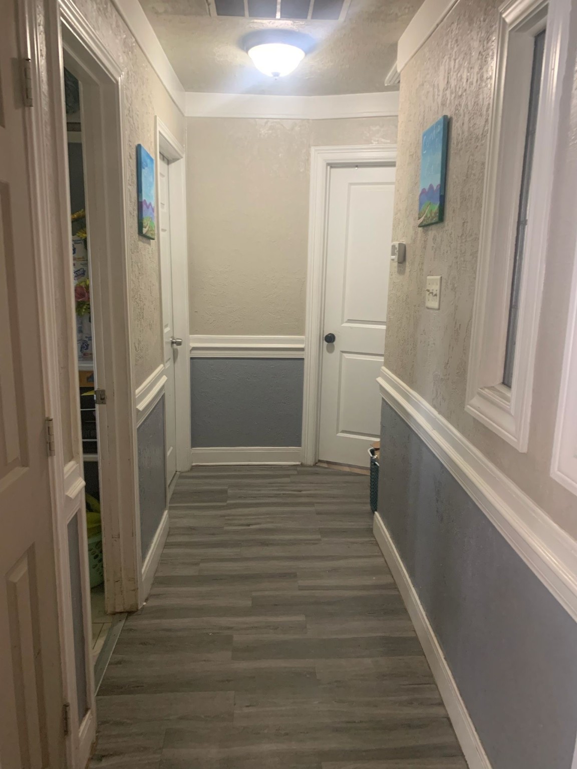 7311 Roswell Street Houston, TX 77022 - Photo 12 of 18 a view of a hallway with wooden floor and staircase